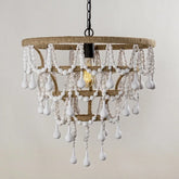 Close-up view of a bohemian chandelier featuring white wooden beads and jute rope wrapped around the frame, with a single exposed bulb.