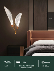 Modern bedroom with a unique pendant light fixture.