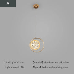 Gold pendant light with circular design on a gray background