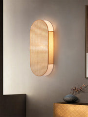 Modern wall lamp with textured design on a neutral wall