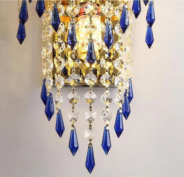 Crystal lampshade with blue and clear glass droplets on a light gray background