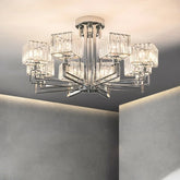 Close-up view of a polished chrome multi-arm chandelier with clear crystal shades illuminated.