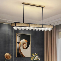 Modern pendant light fixture in a room with decorative elements.