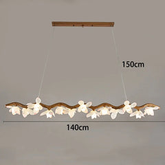 Decorative ceiling light fixture with branch-like design and floral elements, shown against a plain background.