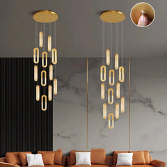 Gold chandelier hanging above a sofa with a marble wall background