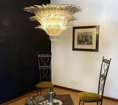 Decorative chandelier hanging above a table with chairs in a room.