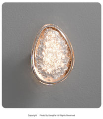 Decorative wall light fixture on a gray wall