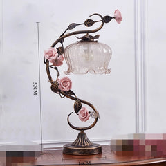 Decorative table lamp with floral design on a white background