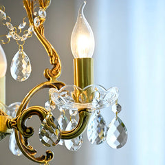 Close-up of a chandelier with crystal accents and a blurred background