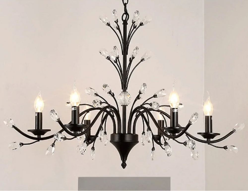 Black chandelier with crystal accents on a plain background