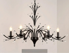 Black chandelier with crystal accents on a plain background