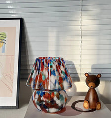 Colorful lamp with a wooden bear figurine.