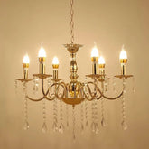 Gold tiered crystal chandelier with cascading waterfall elements and candle-style bulbs.