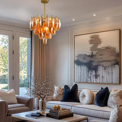 Amber faceted crystal chandelier with a tiered design hanging in a bedroom.