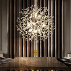 Luxurious chandelier hanging above a wooden table with a neutral background