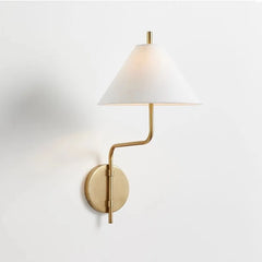 Wall-mounted lamp with a white shade and gold arm on a light gray background