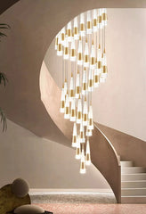 Modern chandelier hanging in a staircase with a neutral color palette