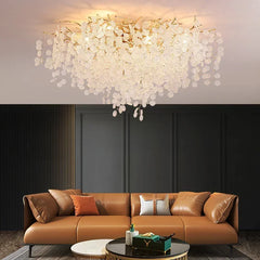 A living room featuring a gold cascading crystal floral chandelier as a central focal point.