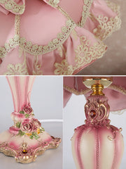 Decorative pink and gold lamp with intricate designs on a light background