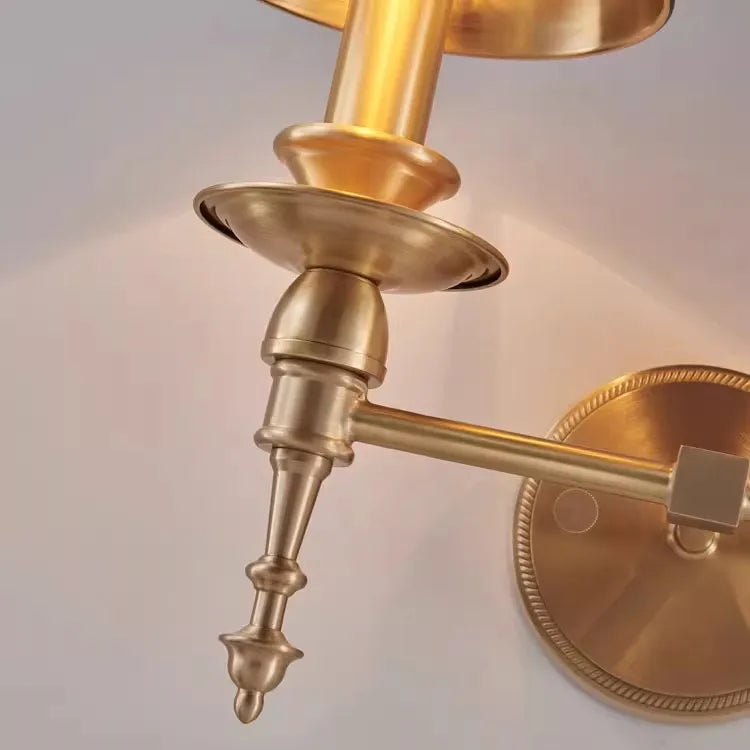 Brass wall sconce on a light gray background