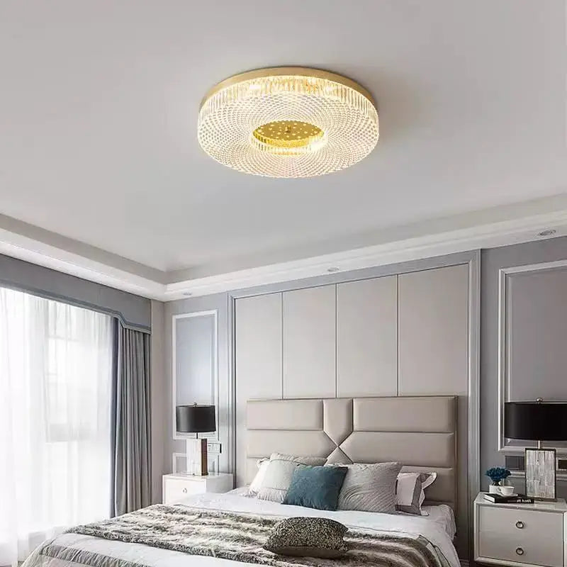 Modern bedroom with a ceiling light fixture, bed, and side tables.