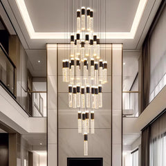 Luxurious chandelier hanging in a modern interior setting with light-colored walls and ceiling.