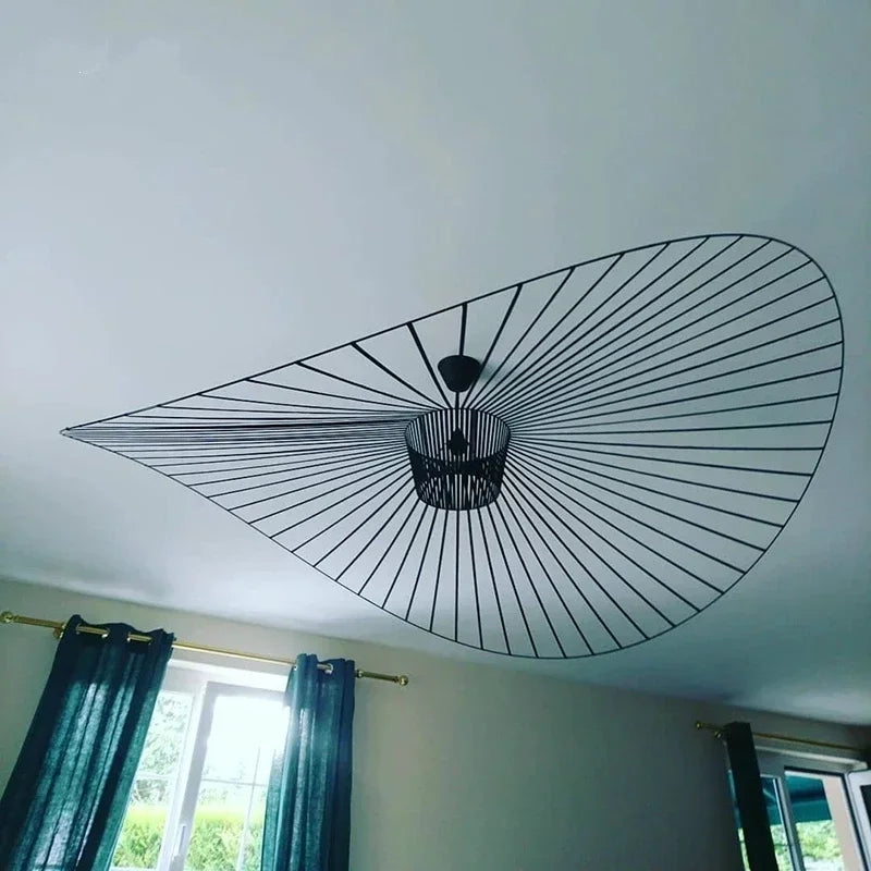 Ceiling fan mounted on a white ceiling with curtains and a window in the background