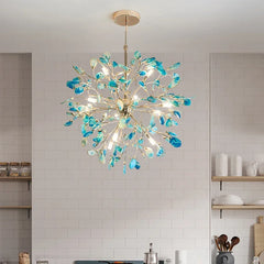 A blue agate slice floral chandelier with a gold frame hanging in a kitchen setting.