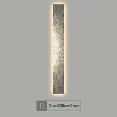 Tall vertical light fixture with decorative glass on a gray background