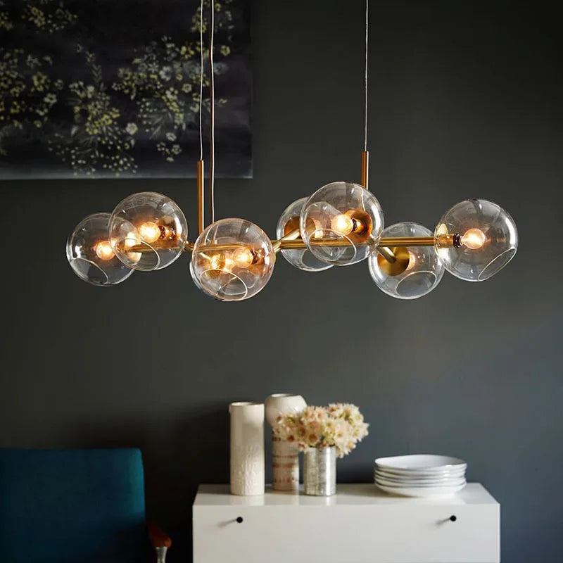 A close-up view of the smoked gray glass globes on a modern chandelier, showcasing the internal LED bulbs and black metal accents.