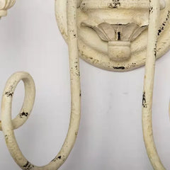 Vintage-style wall sconce with distressed finish on a white background