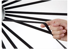 Hand holding black tape against a white background