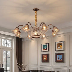 Bronze floral glass shade chandelier installed in a living room setting.