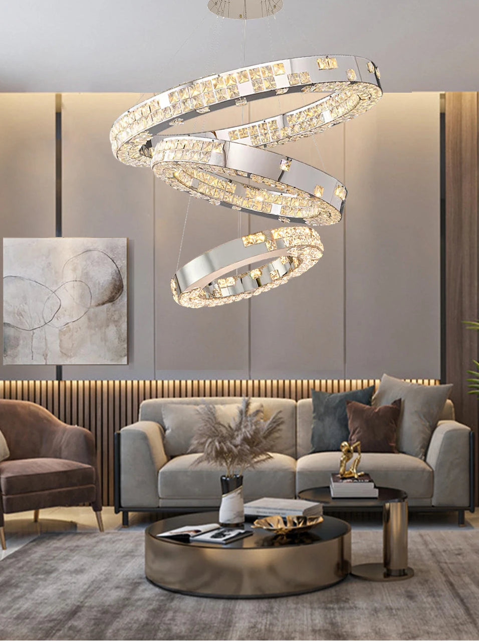 Modern living room with a stylish chandelier, gray sofa, and round coffee table.