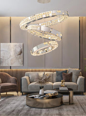 Modern living room with a stylish chandelier, gray sofa, and round coffee table.