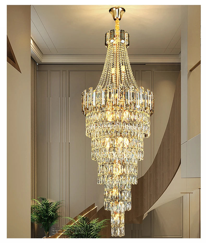 Chandelier hanging in a room with neutral walls and a plant.