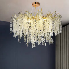 Close-up view of the intricate gold metalwork and clear circular crystal elements of the pendant light.
