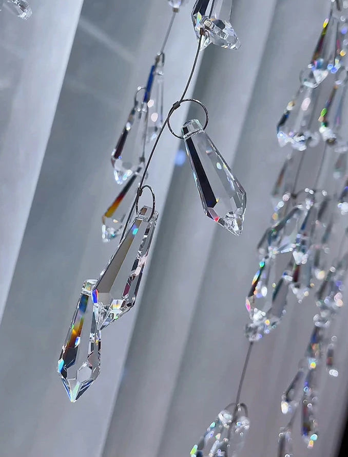 Crystal prisms hanging against a neutral background