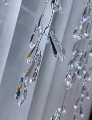 Crystal prisms hanging against a neutral background