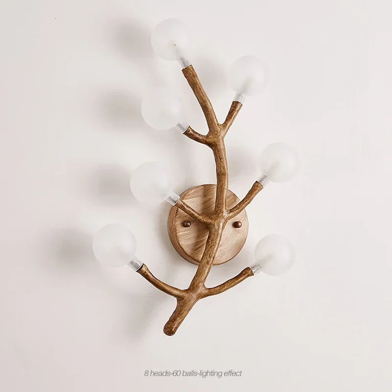 Wooden wall sconce with antler design on a white background