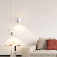 Modern living room with a beige sofa, small round table, and pendant lights.