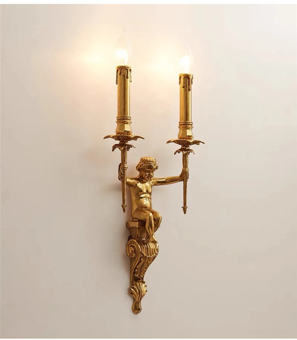 Decorative gold wall sconce with classical design on a plain background