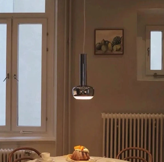 Dining room with a table set for a meal, featuring a cake and tea cups.