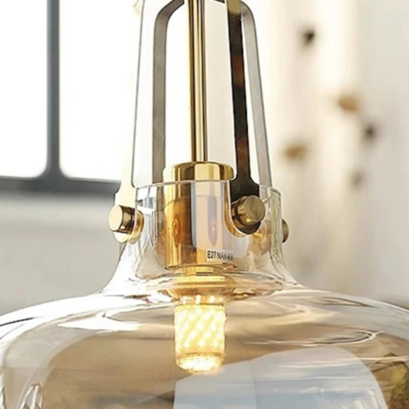 Close-up of a gold pendant light fixture with a blurred background