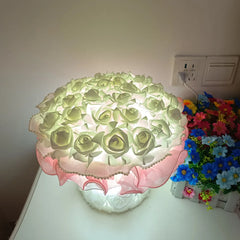 Decorative lamp with floral design on a white surface