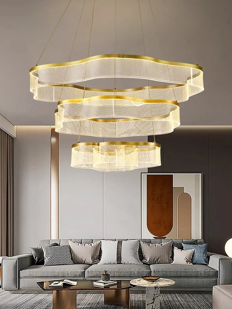 Modern living room with a stylish chandelier, gray sofa, and coffee table.