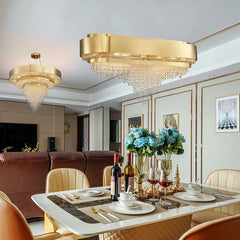 A dining room setting with a gold tiered crystal chandelier hanging above a table, another similar chandelier is visible in the background.
