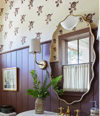 Bathroom interior with wooden vanity, sink, and decorative elements.