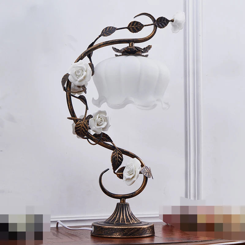 Decorative table lamp with floral design on a white background