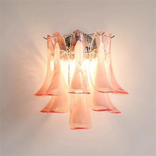 Pink Murano glass petal wall sconce with a chrome finish mounted on a white wall.